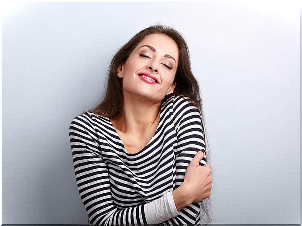 Woman hugging herself.