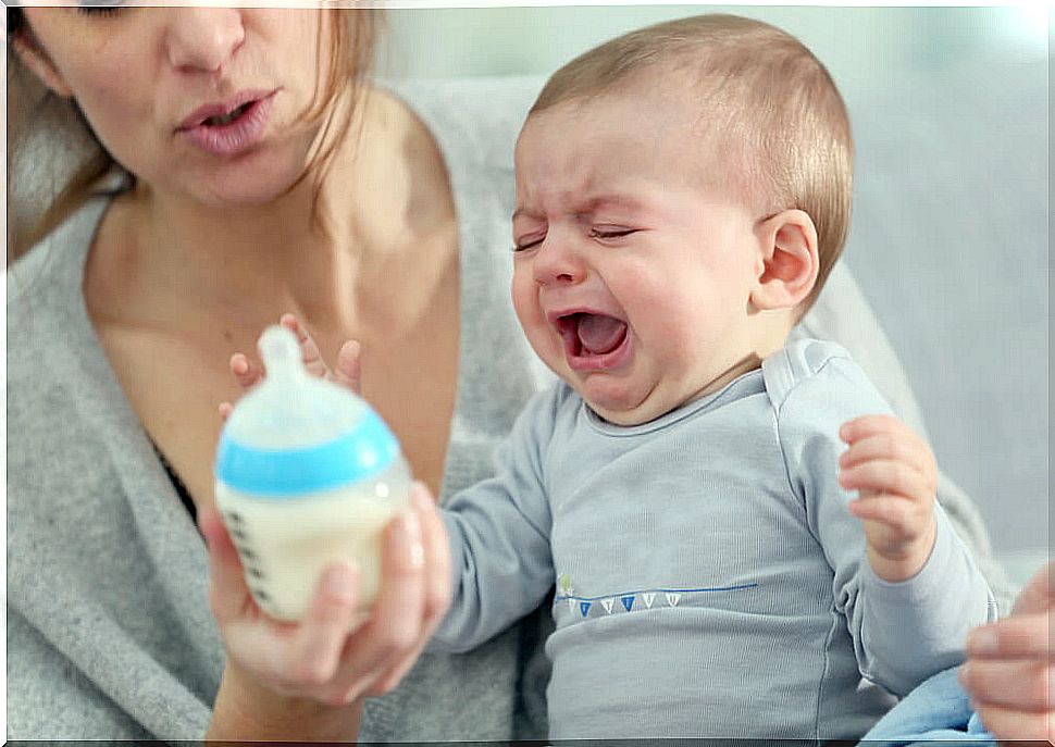 Crying baby with a bottle