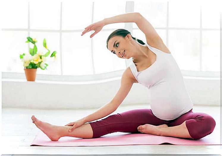 Pregnant practicing yoga