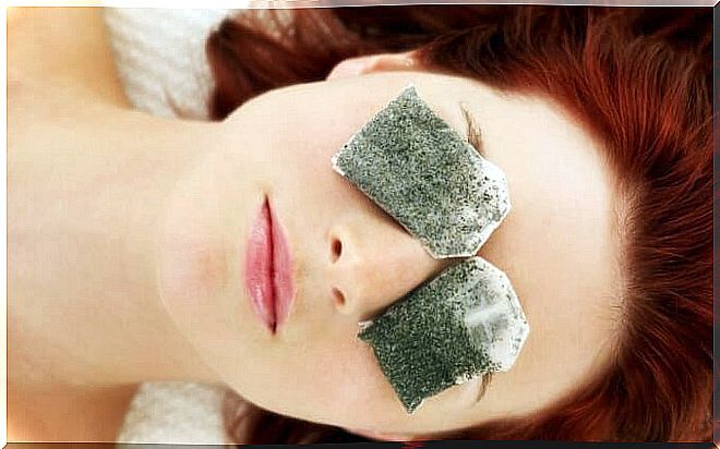Woman with tea bags over her eyes.