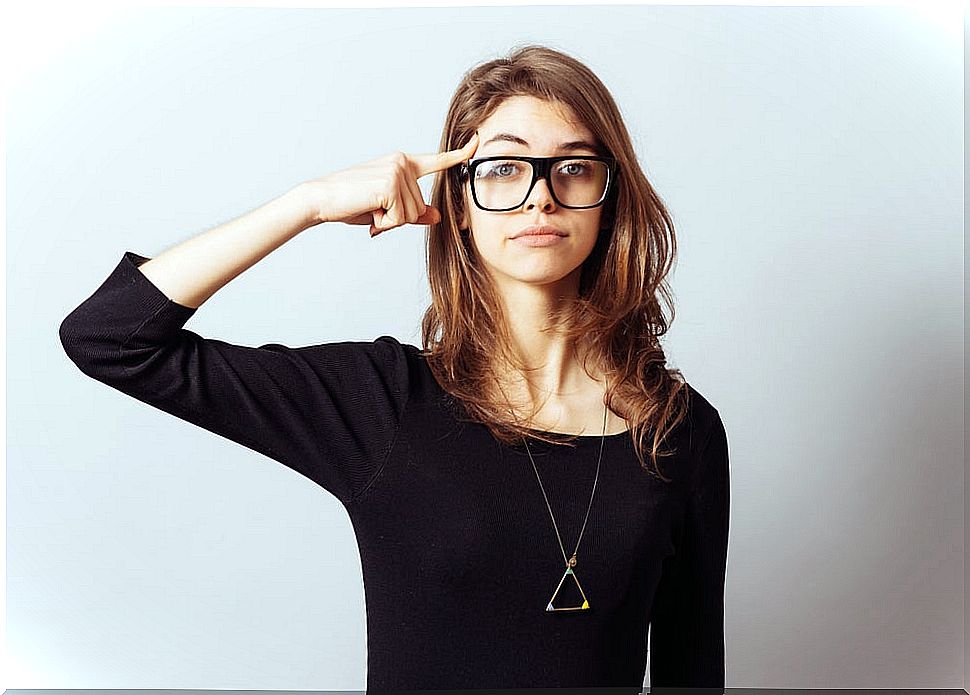 Woman with a finger on her forehead.