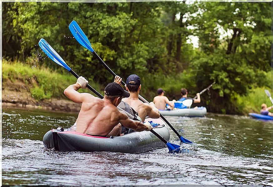 Group of boys paddling in pairs