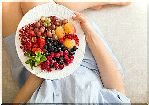 Woman with bowl of fruit.