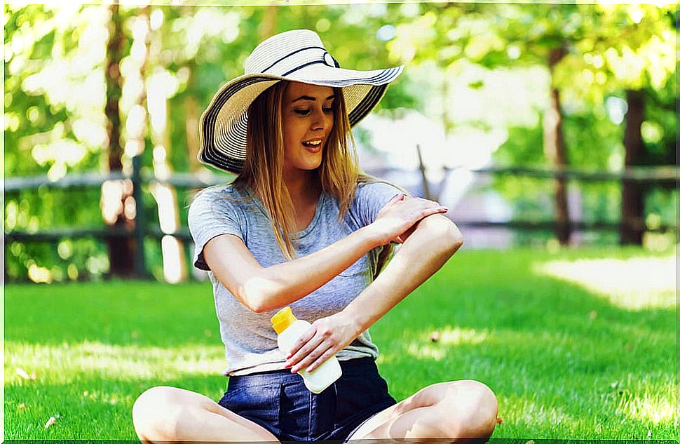 Woman applying sunscreen.